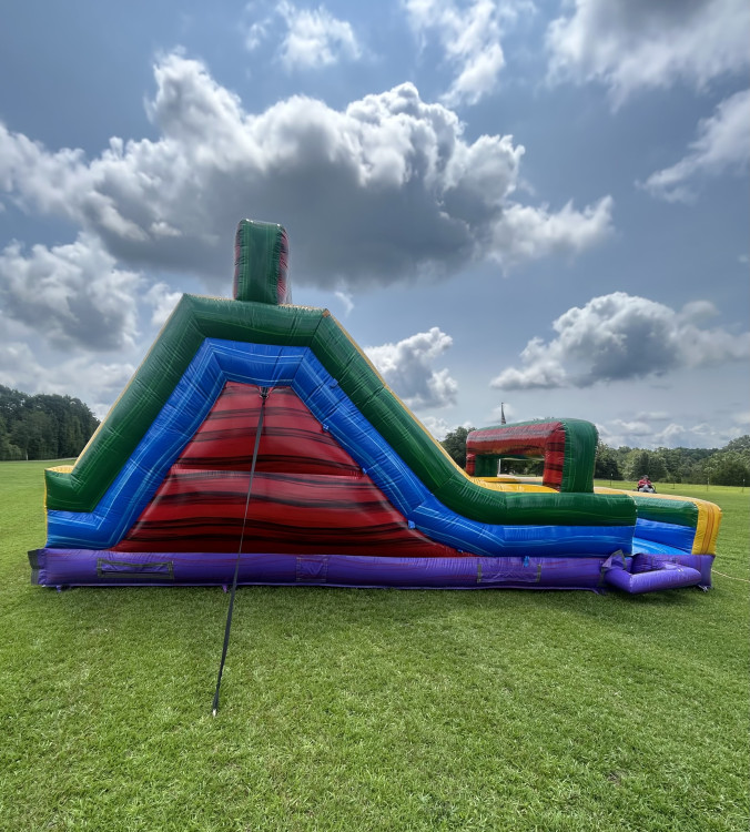 Side view of the 62' 2-Piece Obstacle Course climb and slide set up on a lawn, Milner, GA area